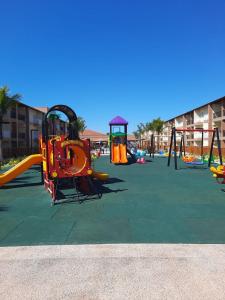 a playground with slides and swings at ONDAS PRAIA RESORT in Porto Seguro