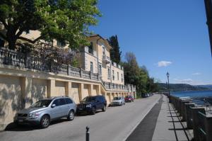 a street with cars parked on the side of a building at Villa Tergeste in Trieste