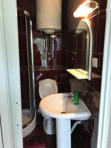 a bathroom with a sink and a toilet and a mirror at Etno village Mihailovic in Herceg-Novi +82 photos