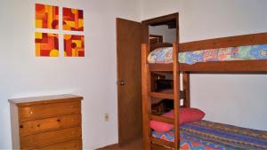 a bedroom with two bunk beds and a dresser at La Chacra Holandesa in Atlántida +23 photos