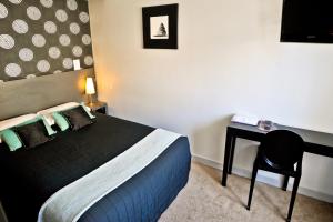 Postel nebo postele na pokoji v ubytování Hôtel Oxo
