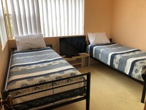 A bed or beds in a room at Salt Water @ Fingal Bay