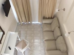 a living room with a couch and a chair at Filoxenia Beach Hotel in Rethymno Town