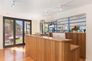 an office with a reception desk and a large window at Hotel Nelson in Nelson Bay