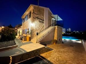 a building with a staircase on the side of it at night at Apartments Nona in Pula