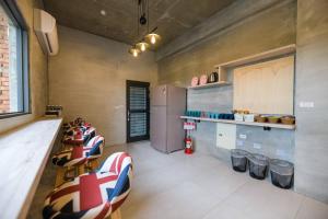 a kitchen with a bunch of chairs and a counter at 澎湖海景民宿 島嶼時光 Island Time Homestay in Magong