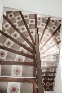 a room with a wooden ceiling with flowers on it at Villa Station by Cassai in Ses Salines