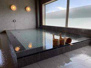 a swimming pool with a pair of shoes on the edge at Yukari no Mori in Fujikawaguchiko