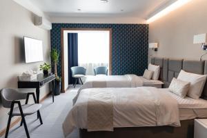 Sea Breeze Vladivostok boutique hotel tesisinde bir odada yatak veya yataklar