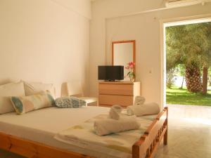 a bedroom with a large bed with towels on it at Lazaris Apartments in Agios Ioannis Lefkada in Lefkada