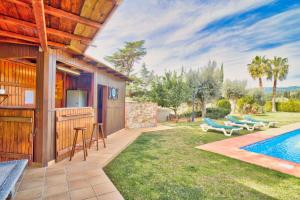 a backyard with a swimming pool and a house at Villamaresme in Sant Andreu de Llavaneres