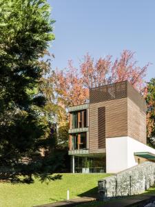 a house on a hill with trees in the background at Casa Sull'Albero in Malgrate