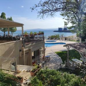 a house with a balcony with a view of the ocean at Helios Hotel in Balchik