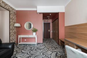 a hotel room with a hallway with pink walls at Matisov Domik Hotel near New Holland Island in Saint Petersburg