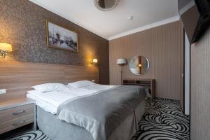 Кровать или кровати в номере Отель Матисов Домик у Новой Голландии