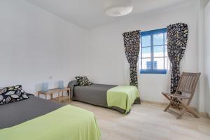 Ένα ή περισσότερα κρεβάτια σε δωμάτιο στο Casa Rosa