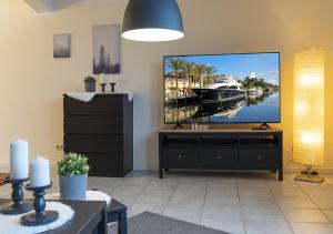 a living room with a large flat screen tv at Harz Living in Clausthal-Zellerfeld