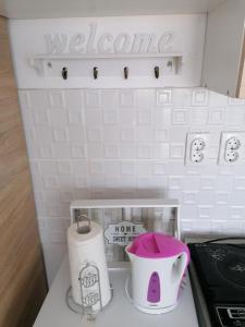 a small refrigerator with a hello kitty pitcher and a pot at Crystal Blue Apartments in Nea Kalikratia