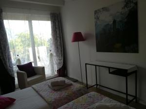 a bedroom with a bed and a chair and a window at B&B Aria d'Argento - Bike Tours in Trento