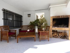 a living room with wooden furniture and a fireplace at INNOUTHOME Casa familiar, piscina a 200m de la playa Ham II in L'Ametlla de Mar