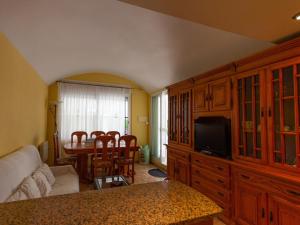 a living room with a couch and a table with a tv at INNOUTHOME Casa familiar, piscina a 200m de la playa Ham II in L'Ametlla de Mar