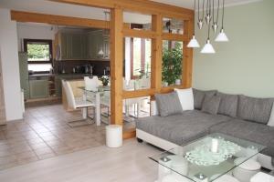 a living room with a couch and a table at Ferienwohnung Rennsteigblick in Riechheim