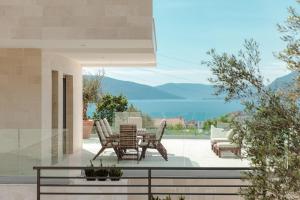 a patio with a table and chairs on a patio at Villa Roc Blanc in Tivat