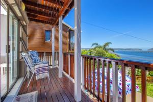 a porch with a chair and a view of the ocean at Paradise View in Knysna +11 photos