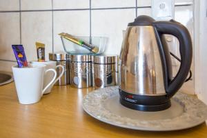 a tea kettle sitting on a counter next to a cup at Paradise View in Knysna