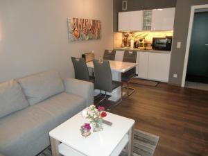 a living room with a couch and a table at Schickeria in Goslar +10 photos