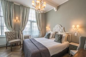 Postel nebo postele na pokoji v ubytování Boutique Hotel Huys van Leyden