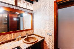 a bathroom with a wooden sink and a mirror at Casa Higuereta II in Corralejo +8 photos