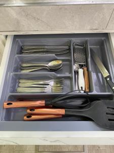 a drawer filled with knives and utensils at Cosy Seaview in Pointe aux Sable