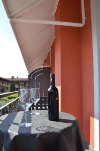 a bottle of wine sitting on a table with two glasses at H2o in Sirmione