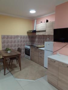 cocina con mesa de madera y mesa y comedor en Laki Apartments & Suites, en Skopje