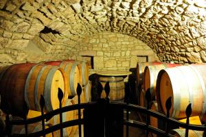 a group of wine barrels in a stone cellar at Der espenhof Landhotel, Tagungshotel & Weingut in Flonheim