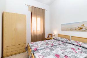 Ένα ή περισσότερα κρεβάτια σε δωμάτιο στο Casa Spiaggia Molo 1