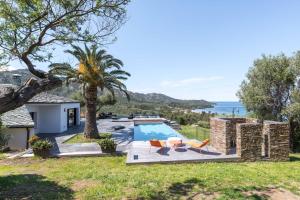 a villa with a pool and a view of the ocean at Les Terrasses de Fromentica in Saint-Florent
