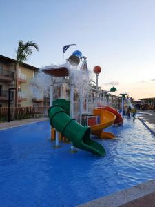 a water park with a slide in the water at ONDAS PRAIA RESORT in Porto Seguro