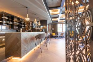 a bar in a restaurant with stools at Hotel B&B Pardeller in Nova Levante