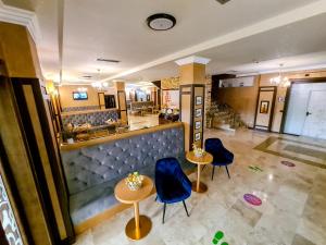 an overhead view of a restaurant with two tables and blue chairs at Hotel Yarus Plus in Ploieşti