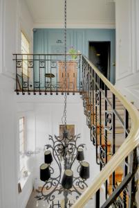 a large staircase leading up to a balcony at L'Hôtel Particulier - Appartements d'Hôtes in Nancy