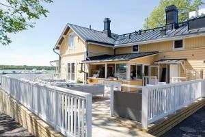 a house with a white picket fence at Hotel Amandis in Naantali