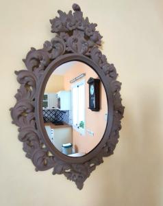 
a mirror with a reflection of a woman in it at Apartment Alacas Sevilla in Seville
