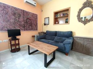 
a living room with a couch and a table at Apartment Alacas Sevilla in Seville
