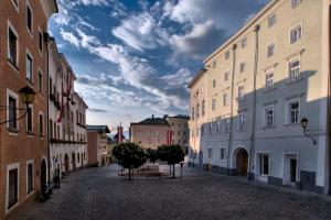 an empty street in a city with buildings at Hotel Kolping Hallein in Hallein