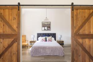 a bedroom with a bed and a sliding barn door at Clopton Courtyard Cambridge in Cambridge