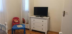 a bedroom with a tv on a dresser at Villa MirIva in Katuni