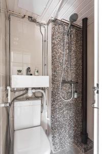 a bathroom with a shower and a toilet and a sink at Newly renovated apartment in a woodenhouse from 1910 in Martti! in Turku