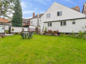 a yard with a table and chairs in front of a house at The Cotswold in Nottingham